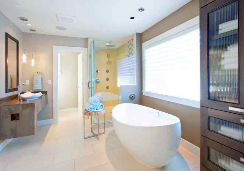 Elegant bathroom remodeling, including dark wood cabinets, double sinks, and new lighting