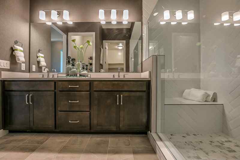 This bathroom remodel modernized the style with new fixtures, flooring, and storage.
