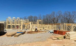 The Amish house builder construction crew for Brian Williams Custom Homes at work framing a house